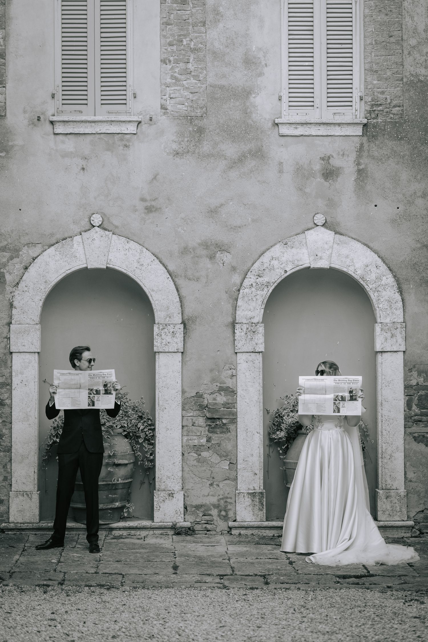 Creative black and white wedding photo sequence using architectural arches and table.