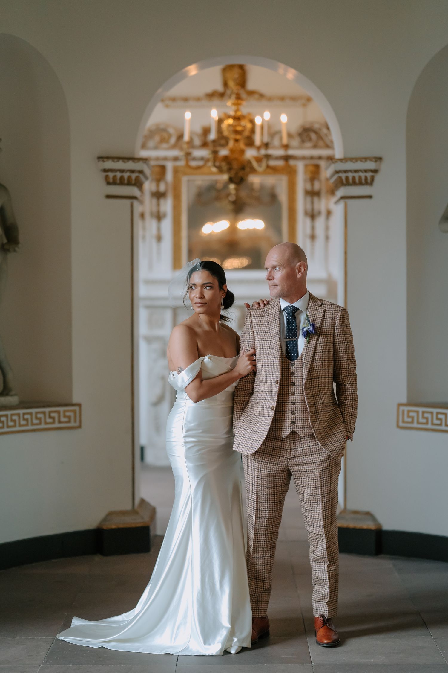 White and gold chapel interior with formal wedding portrait.