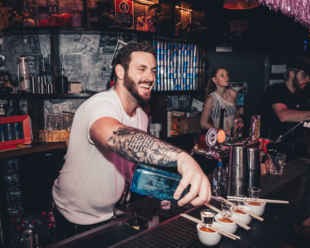 candid photo of a bartender during nightlife party in sydney by sam haber