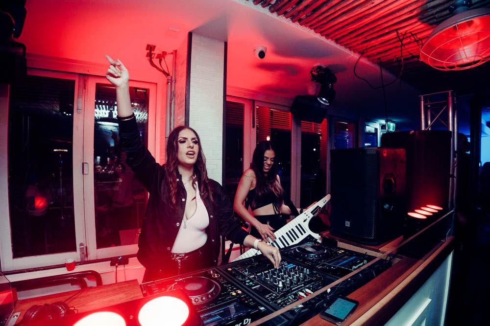 candid photo of a dj playing during nightlife party in sydney by sam haber