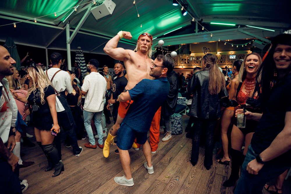 candid photo of a man carrying a man during nightlife party in sydney by sam haber