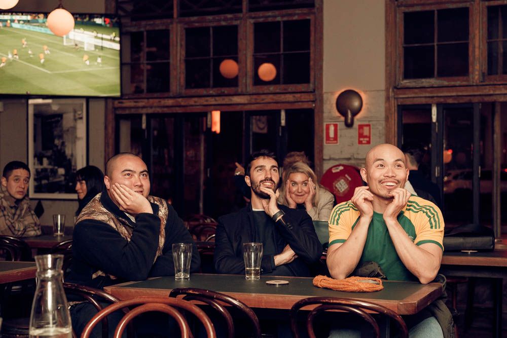 candid photo of a group of people sitting in sydney by sam haber