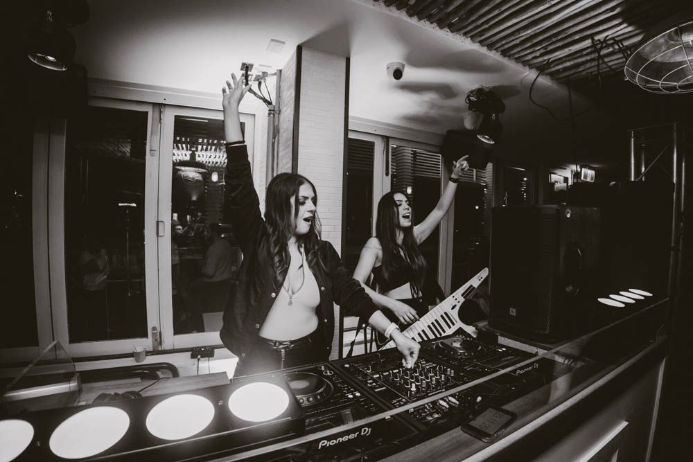 candid photo of a dj playing during nightlife party in sydney by sam haber