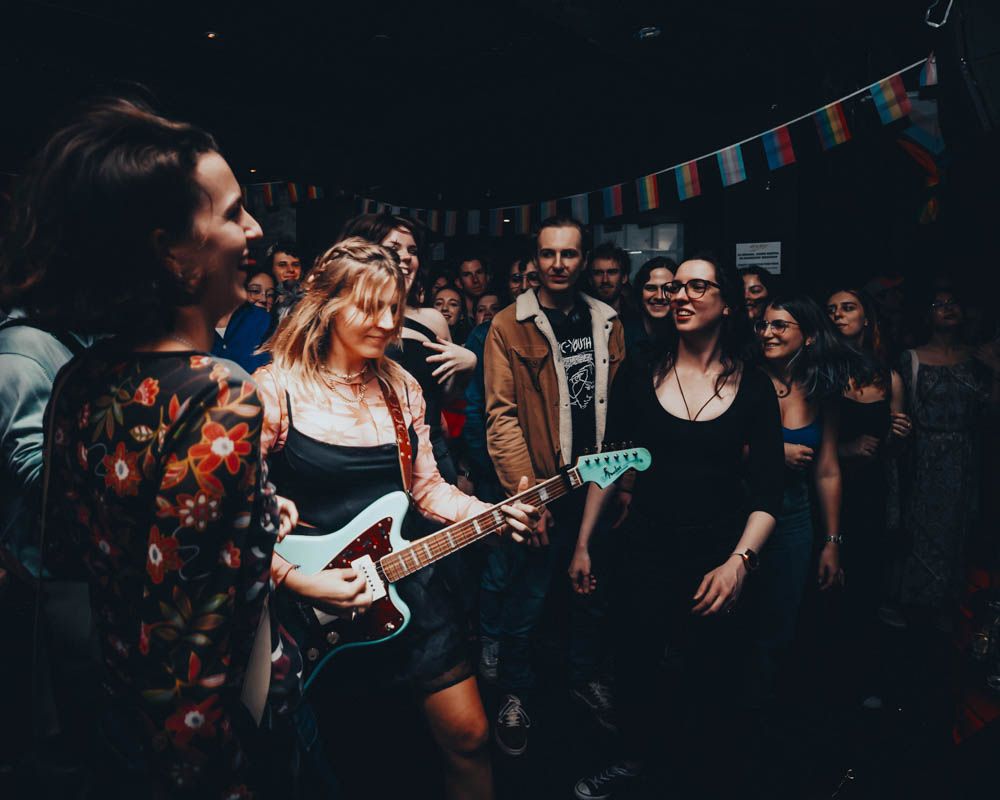 candid photo of a woman playing a guitar during a nightlife party in sydney by sam haber