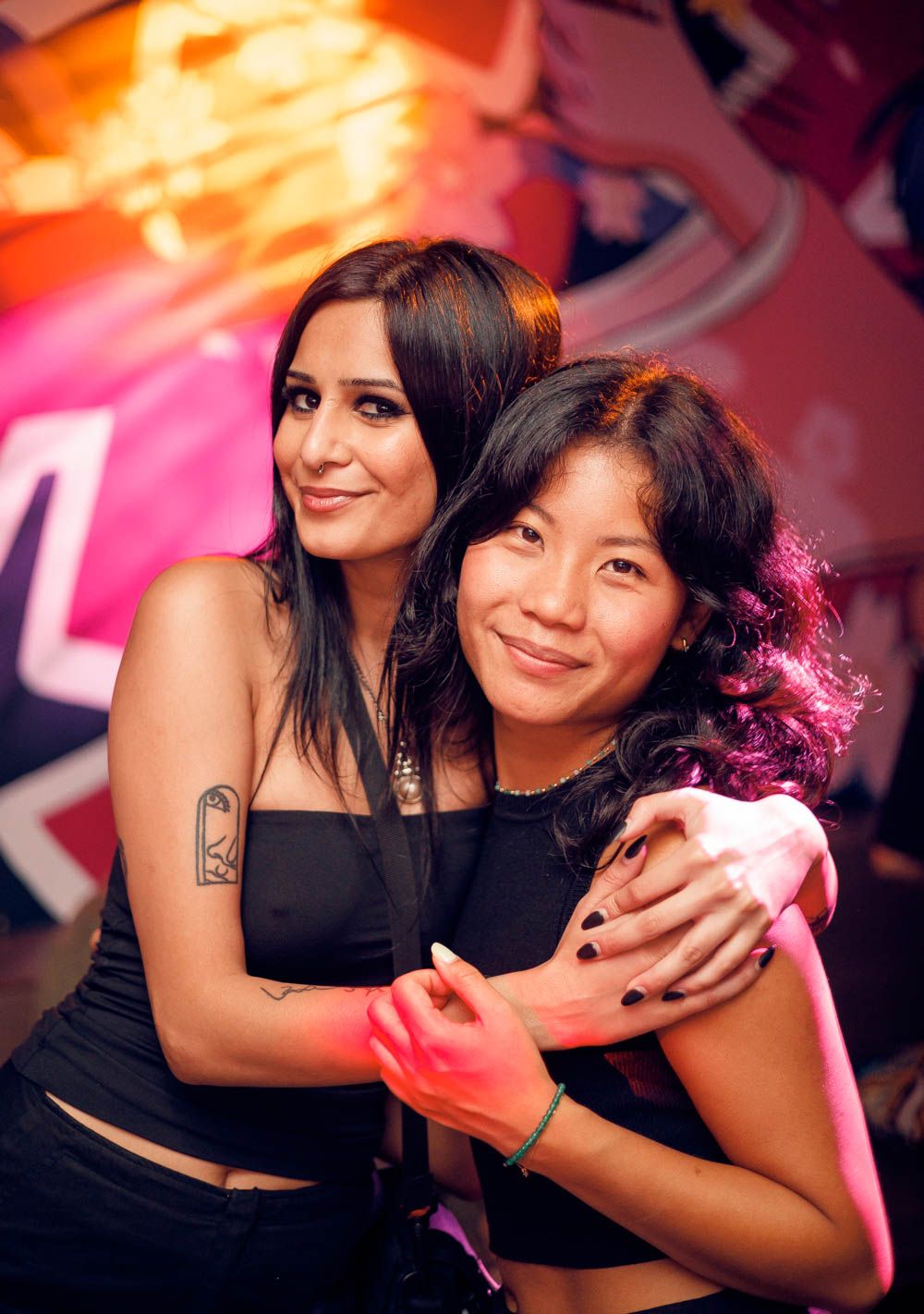 candid photo of two friends hugging during a nightlife party in sydney by sam haber