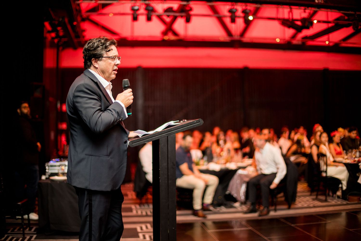 candid photo of a man talking during a corporate event in sydney by sam haber