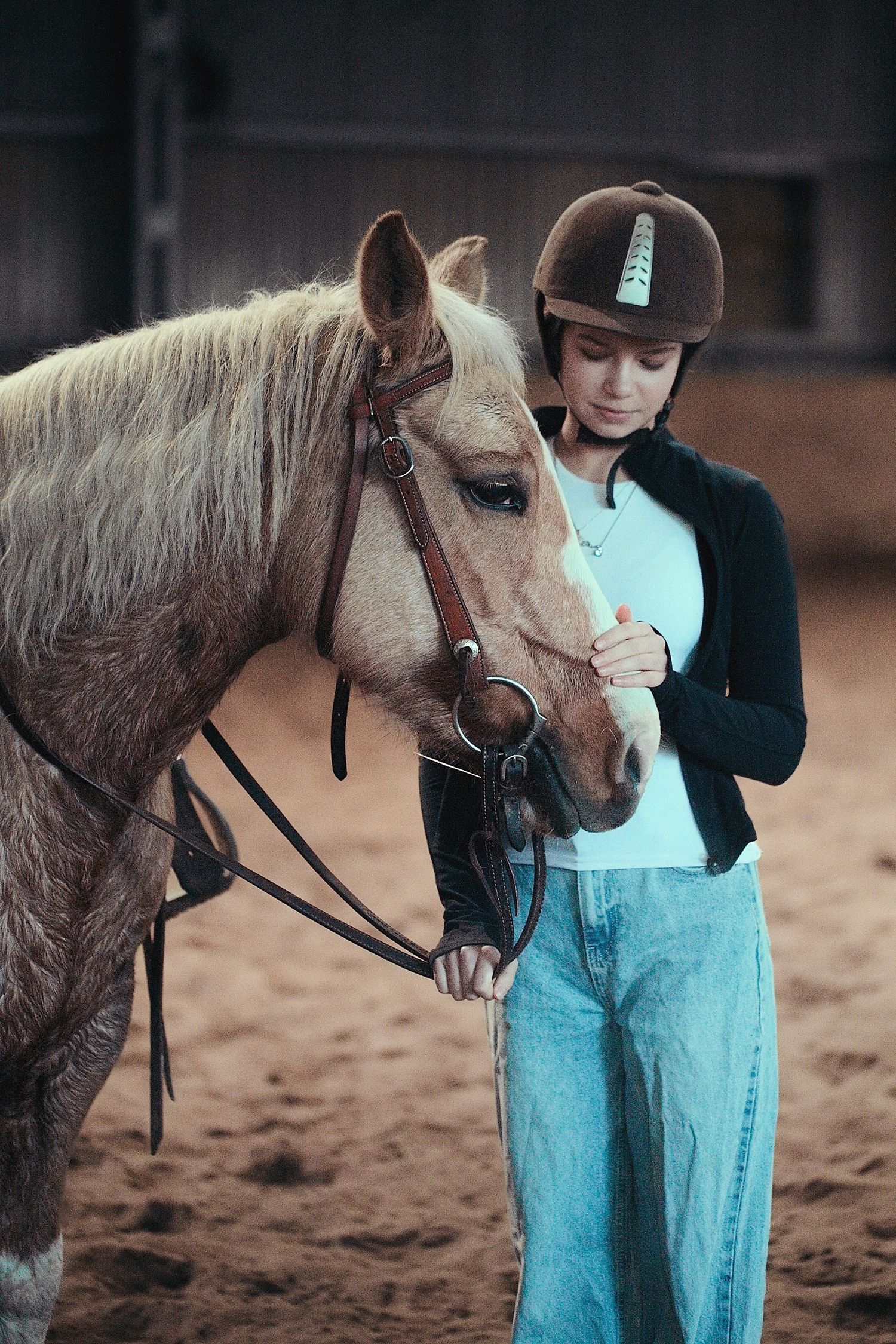 A young person in blue overalls stands next to a brown pony in a series of connected photos showing their interaction.