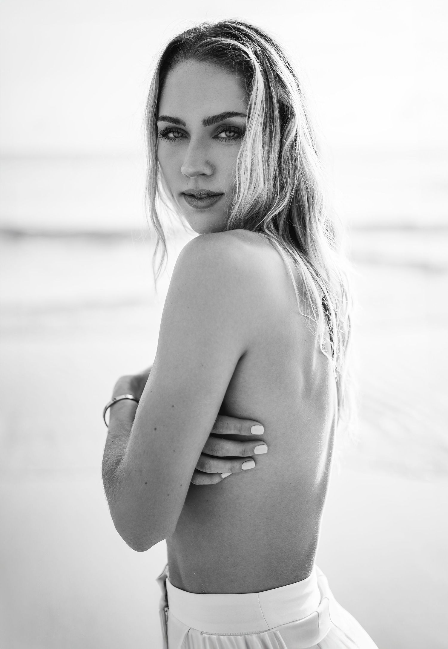 Black and white portrait series showing elegant poses against a light background.