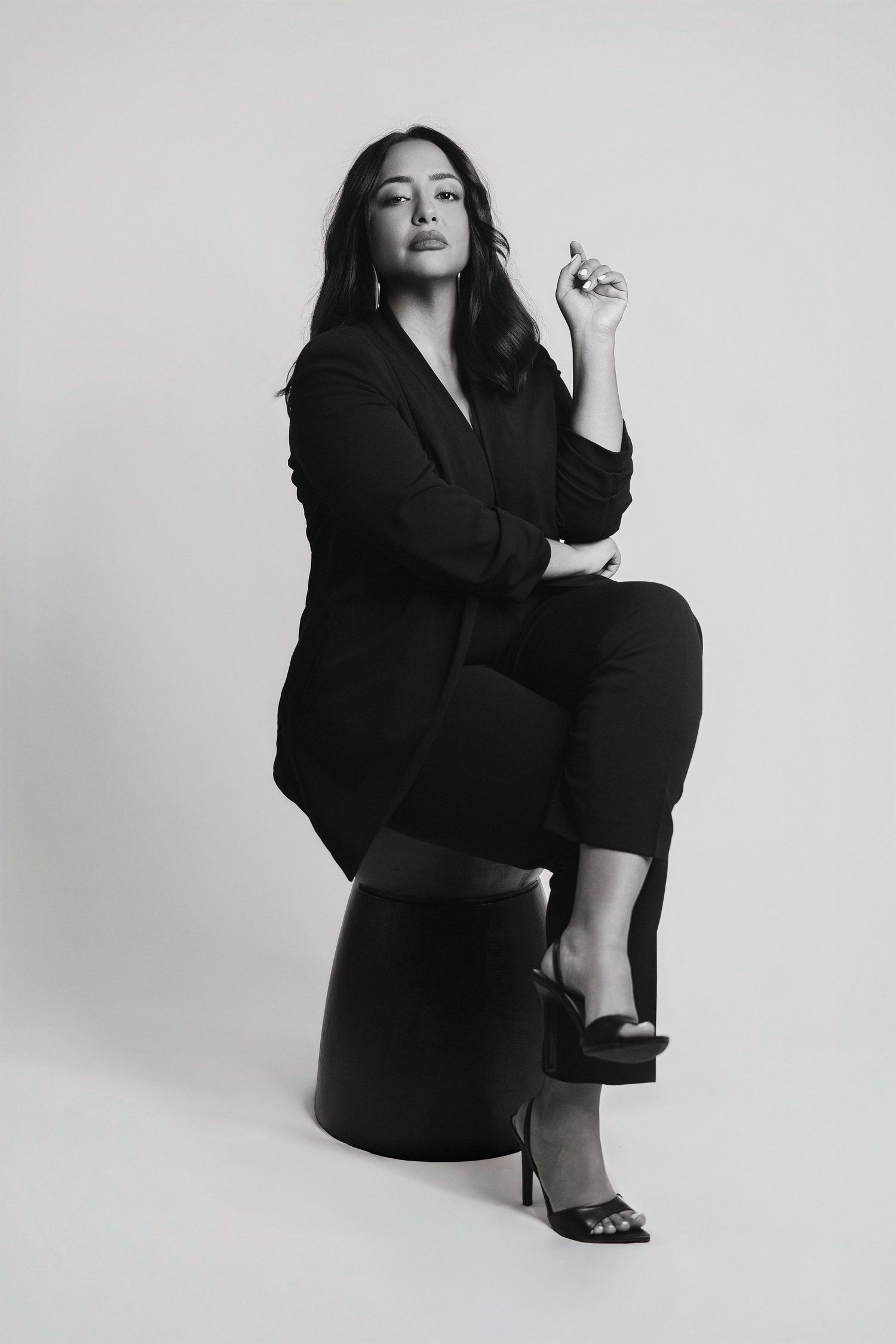 Fashion portrait series in black outfit with dynamic poses against white background.