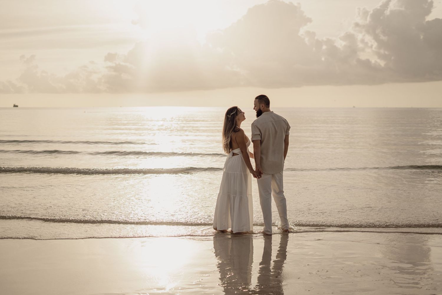 Romantic couple silhouettes walking along a beach at sunset in multiple connected photos.