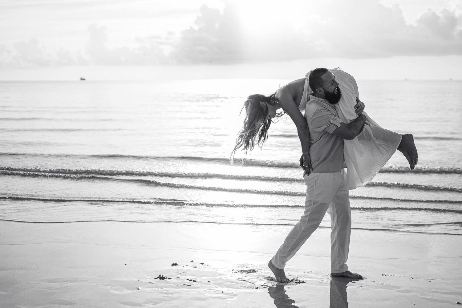 Black and white beach photography series capturing romantic dance-like poses.