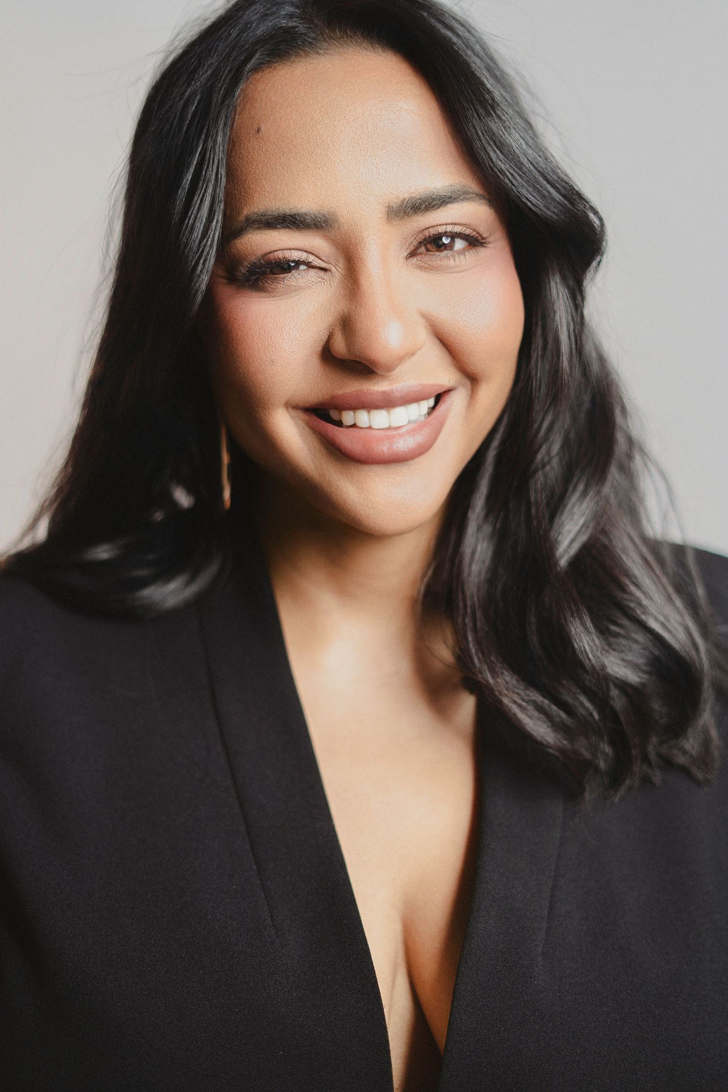 Professional headshot series showing warm expressions against a white studio backdrop.