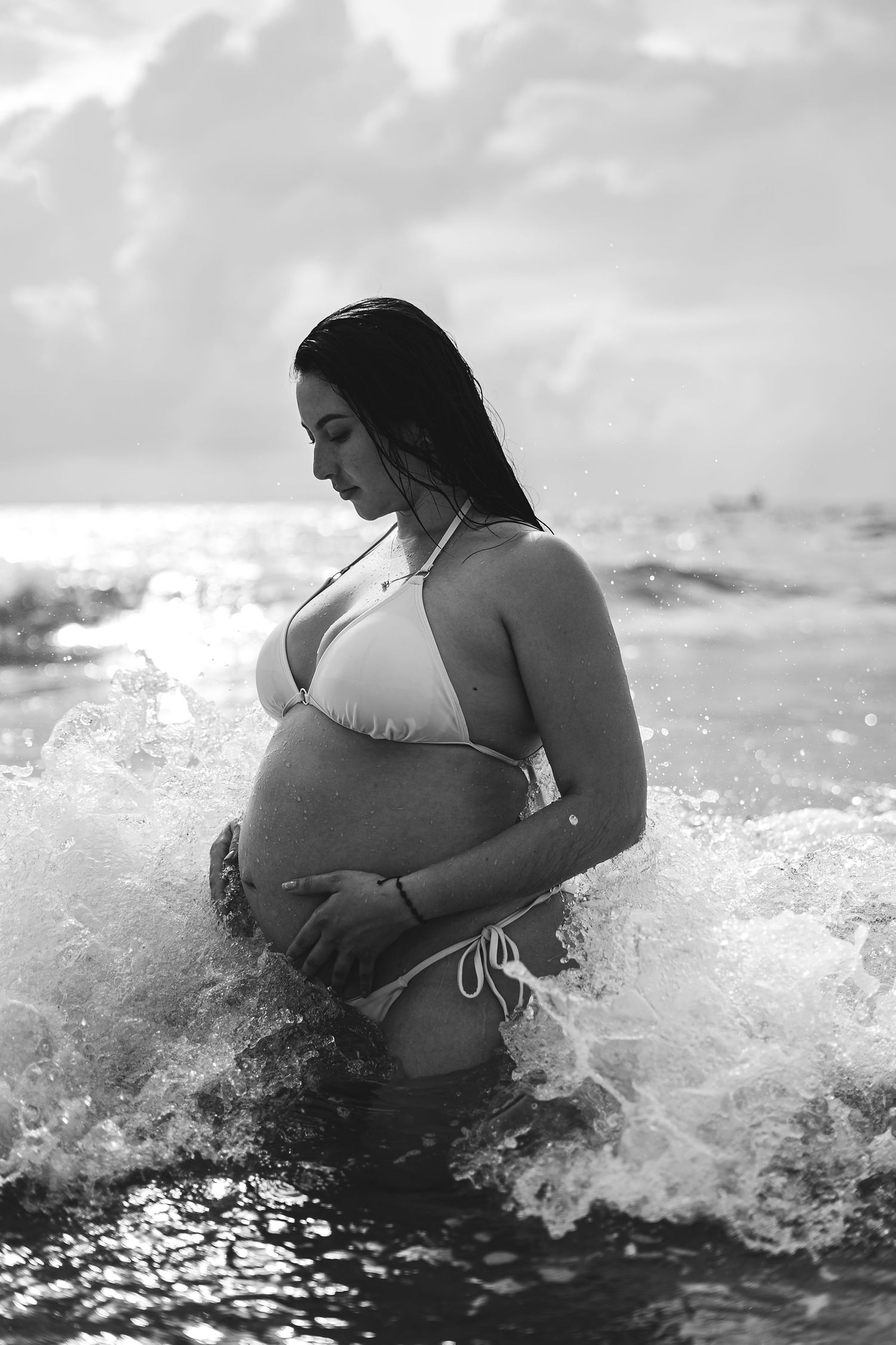 Black and white ocean photography capturing splashing waves and intimate moments.