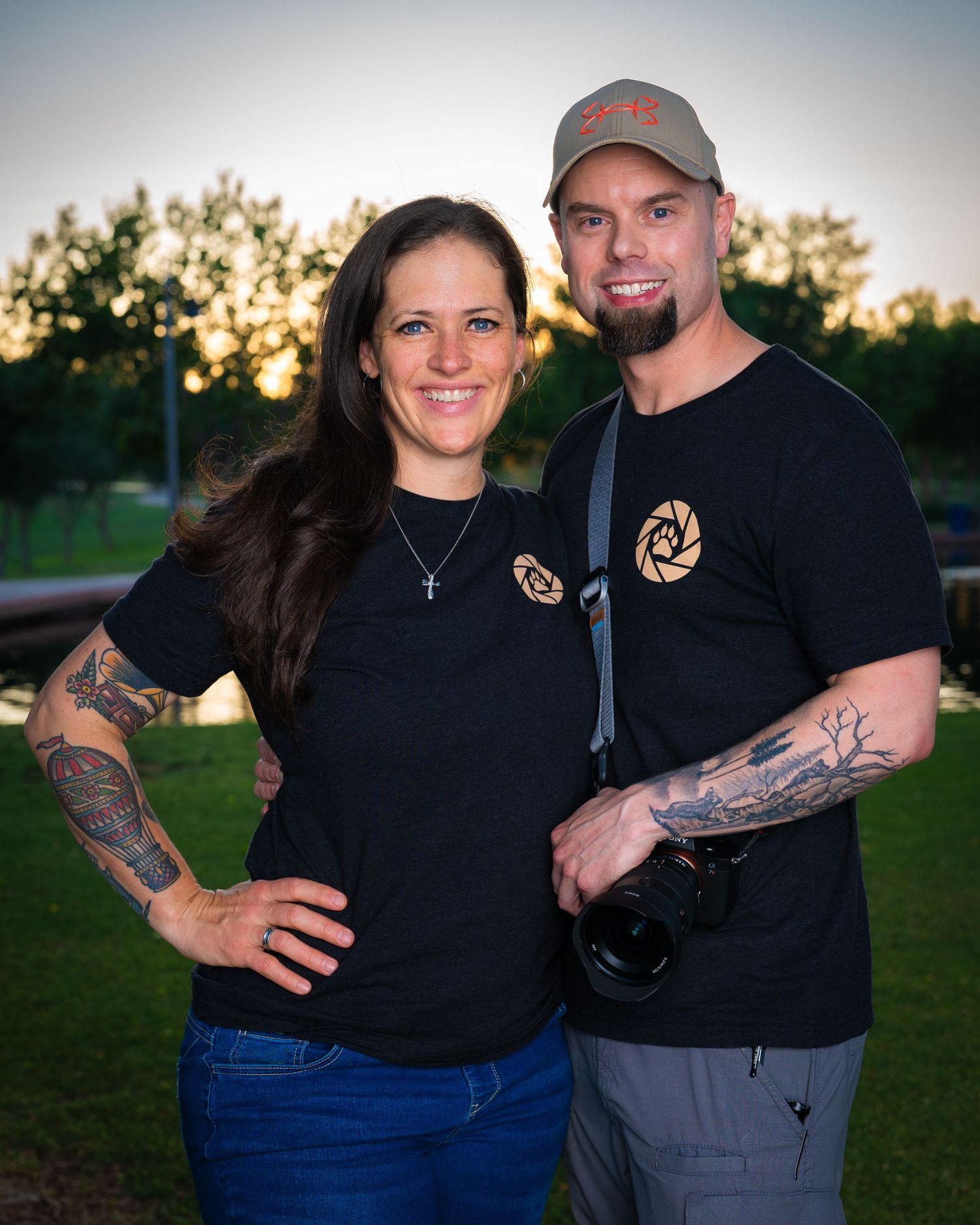 Brian and Kathy Farrelly, the founders of Dog Days Pet Photography, posing for an outdoor portrait at sunset.