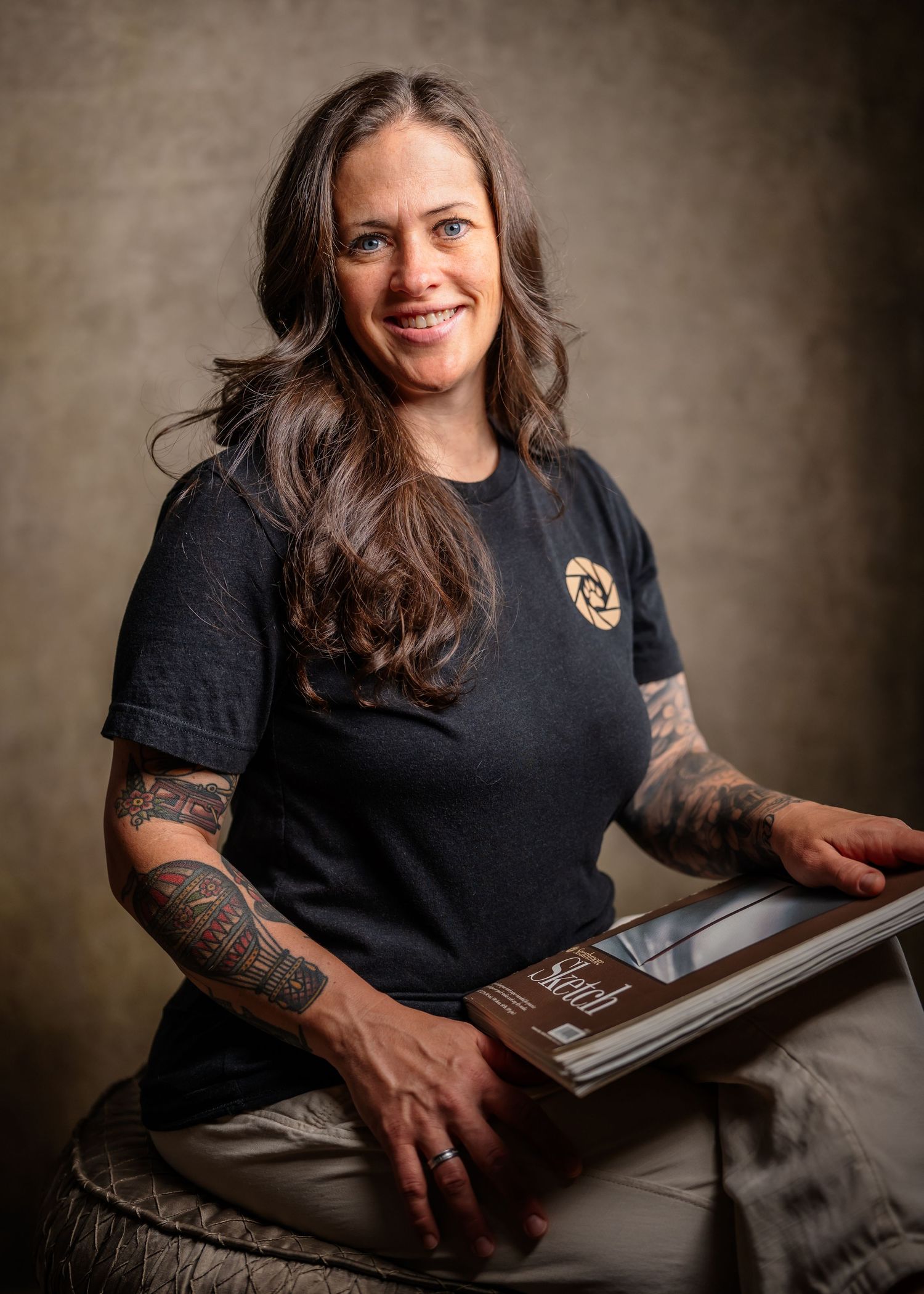 Dog Days Pet Photography co-founder Kathy Farrelly holding a custom fine art photo album.