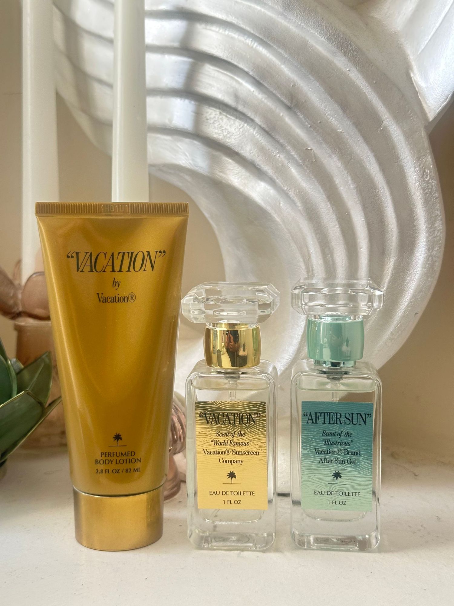 Three skincare products from the Vacation brand collection displayed against a white ribbed background.