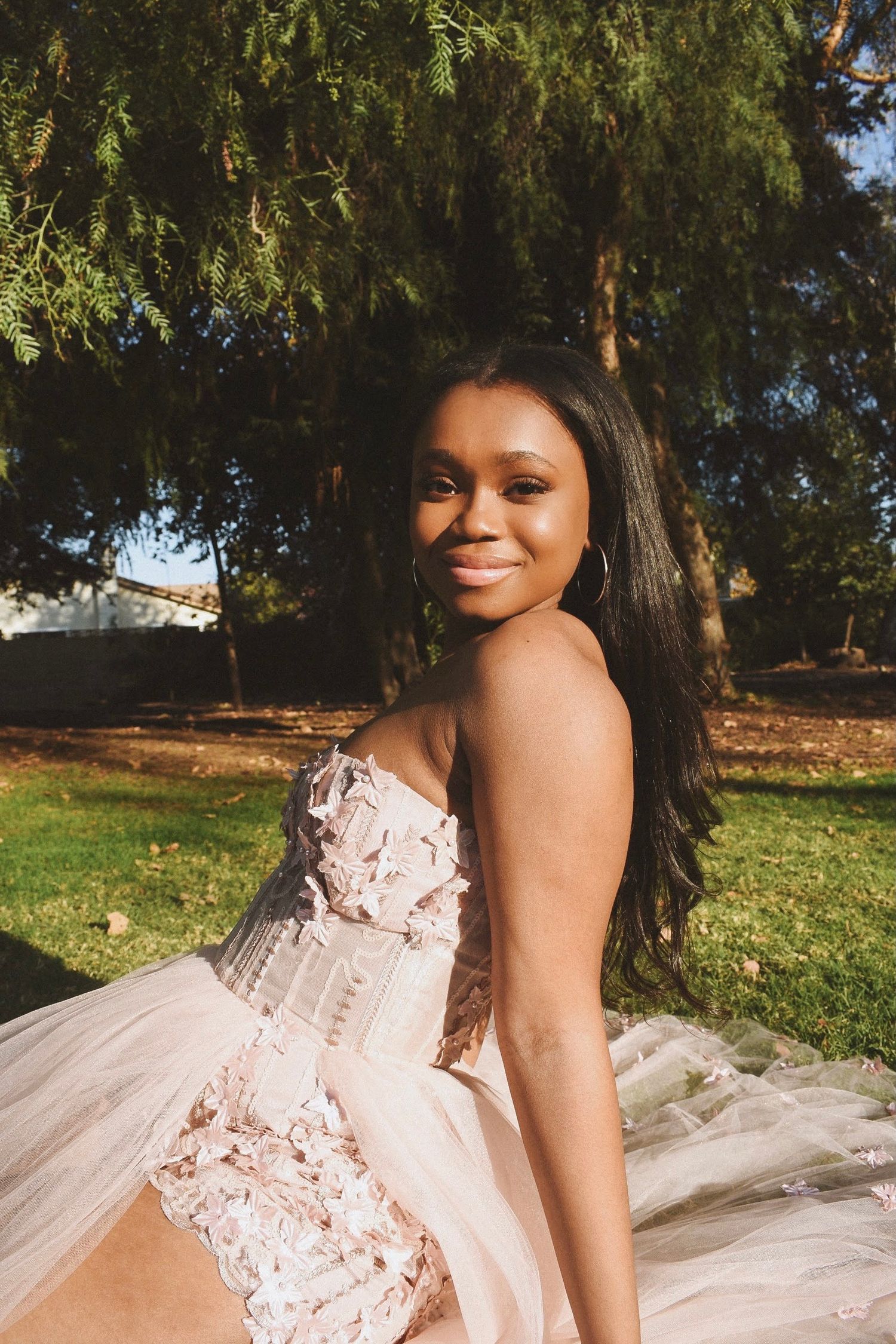 Romantic outdoor photoshoot featuring a detailed lace and tulle ballgown.