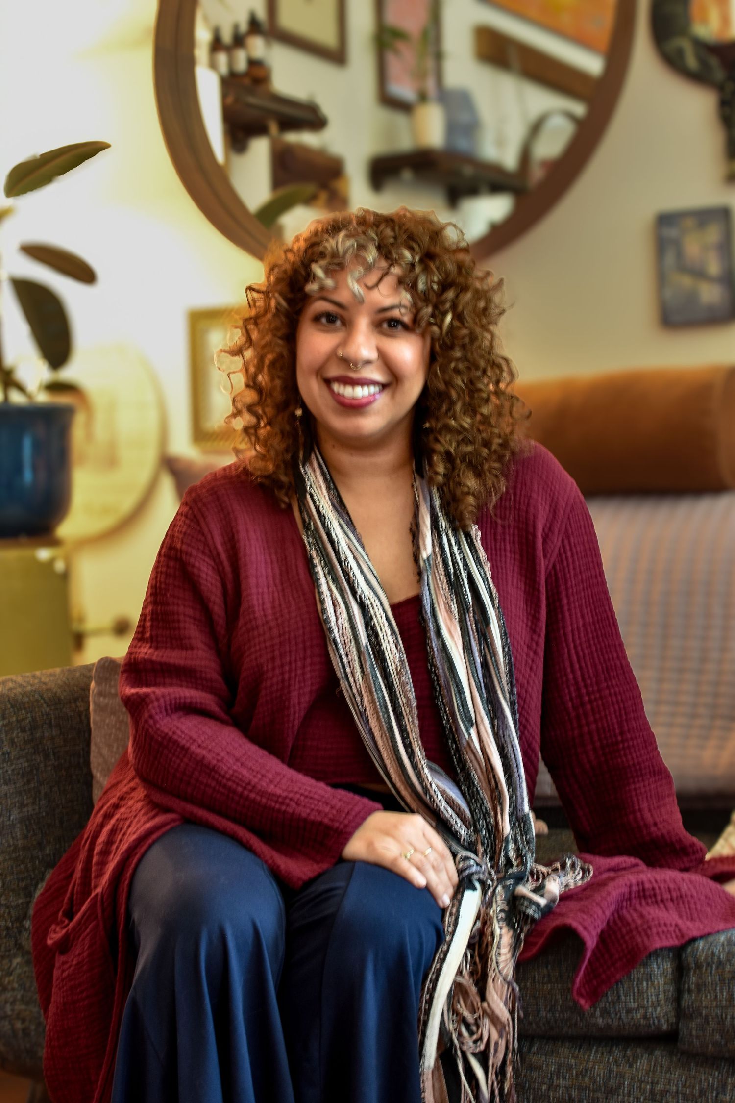A sequence of indoor photos featuring someone wearing a maroon sweater and striped scarf seated on a couch.