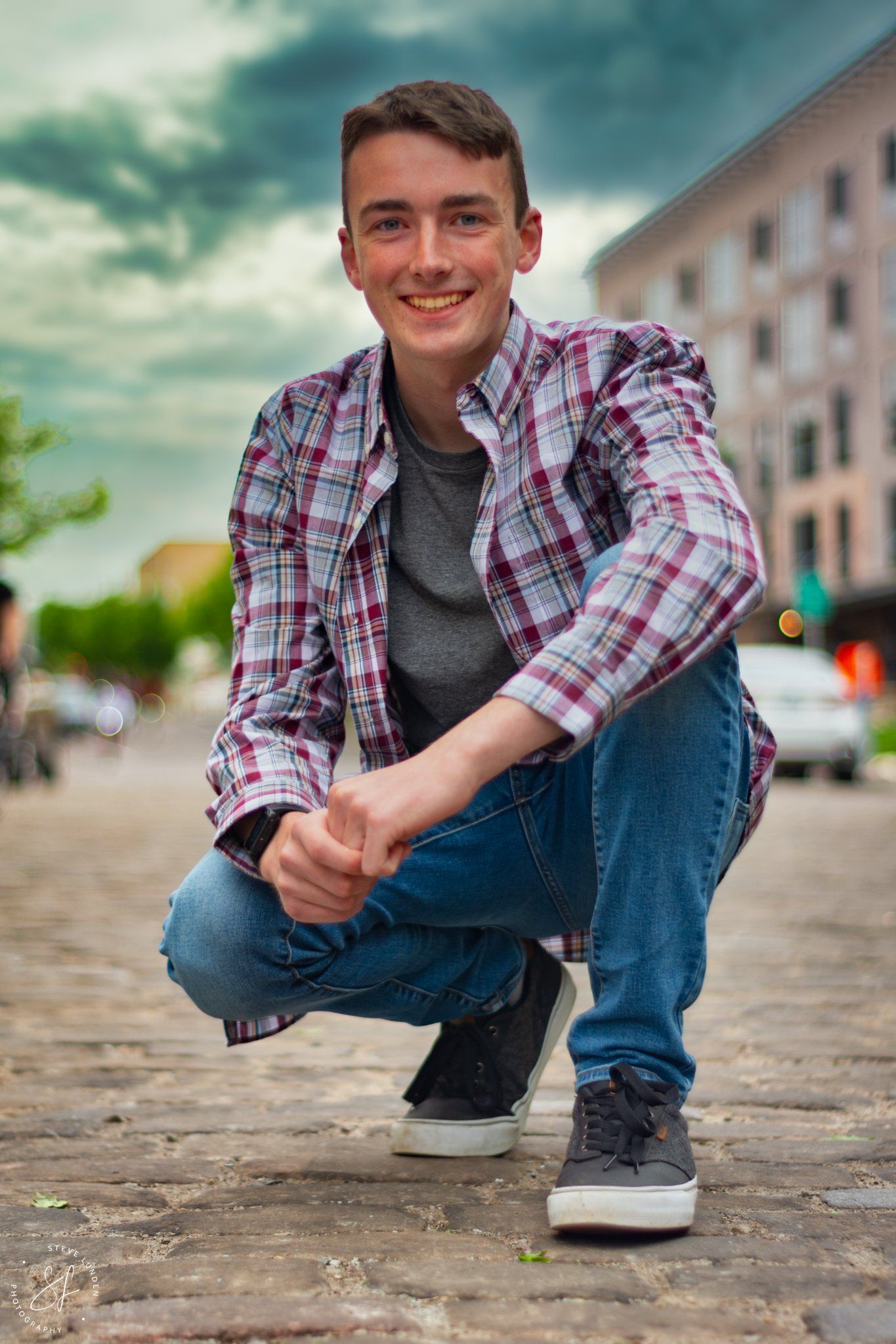 high school seniot posing with street in background