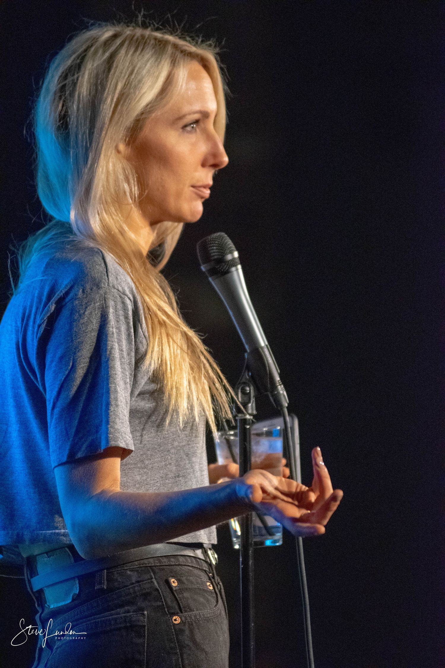 side view of female comedian on stage