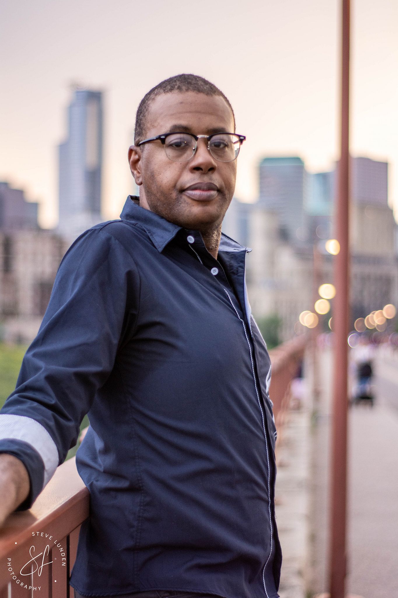 a man with minneapolis skyline in background