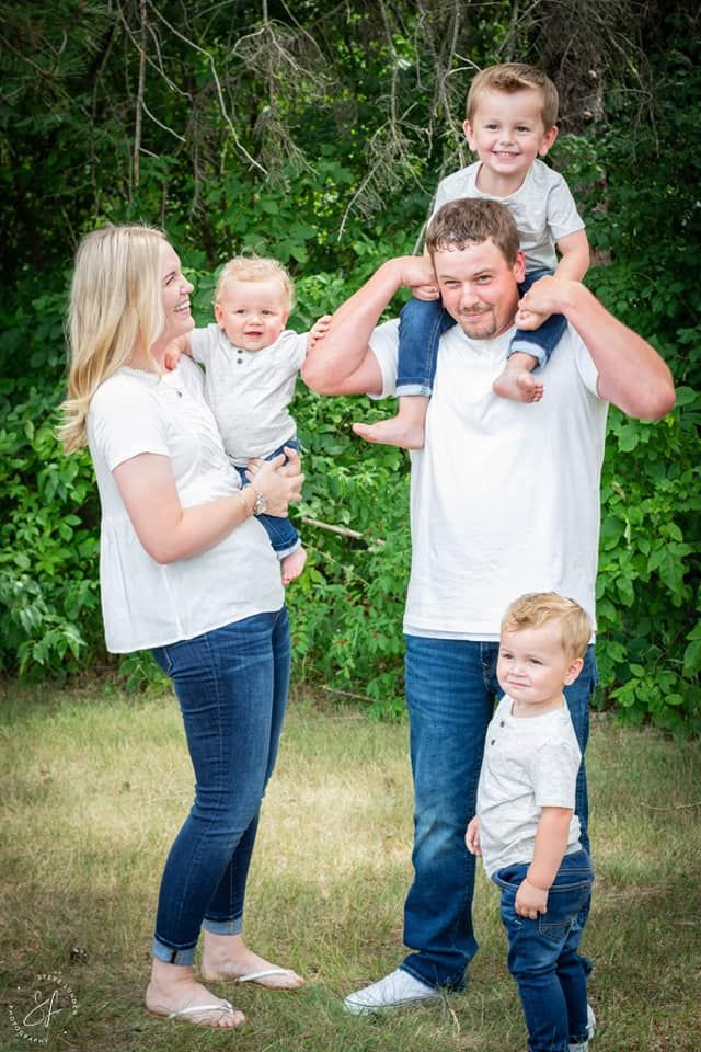 young couple posing with their 3 children