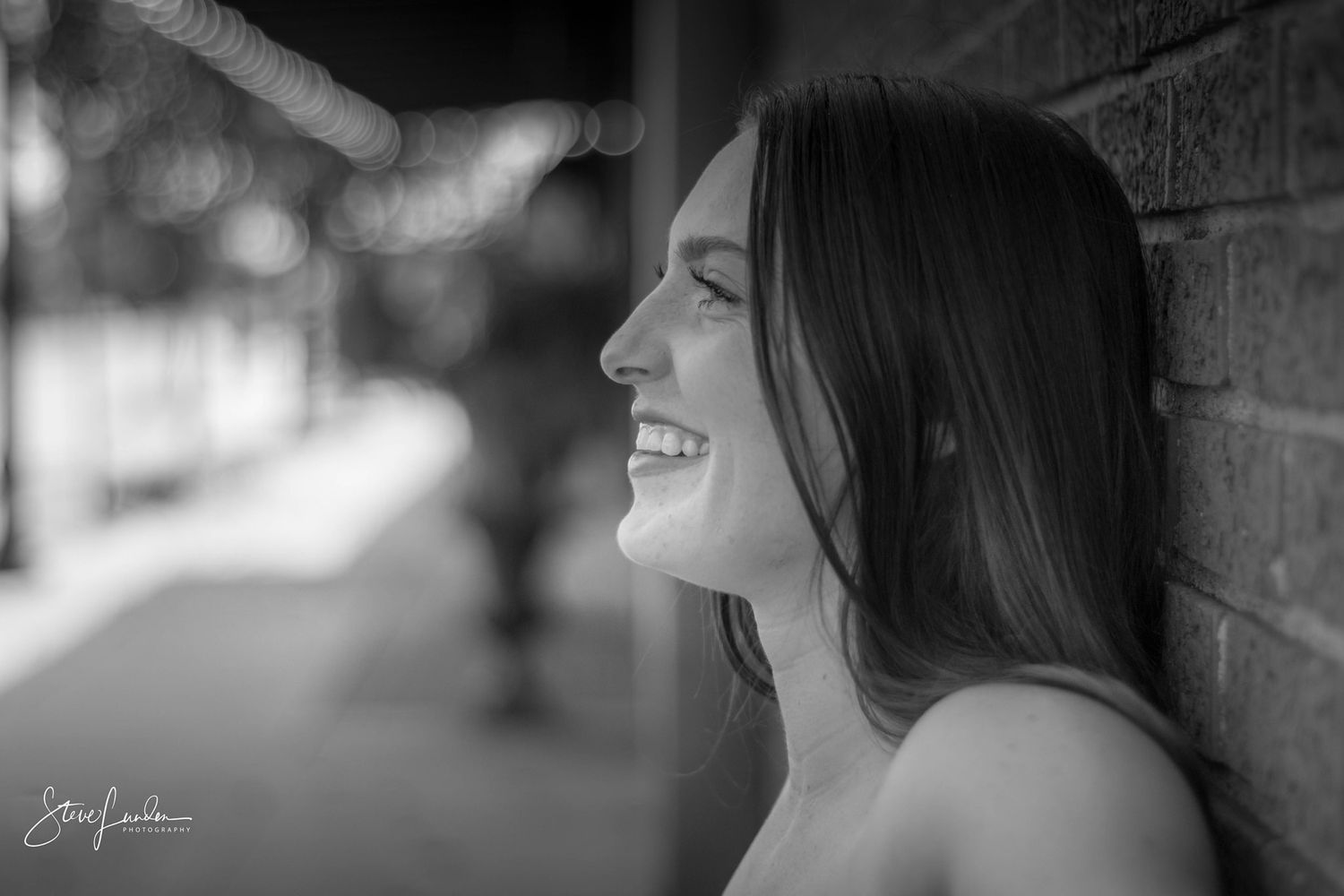 black and white photo of young woman smiling