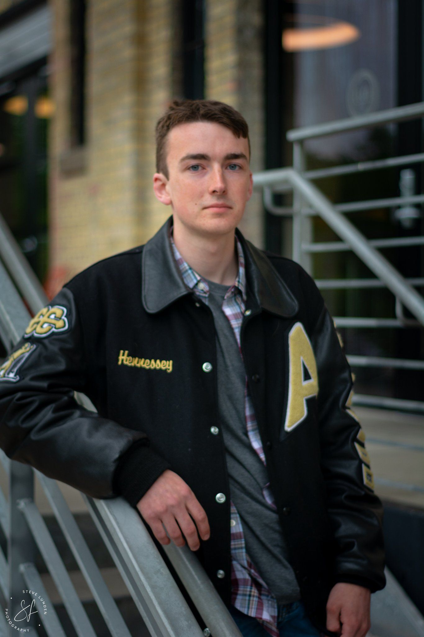 teenage boy posing on indudtrial steps