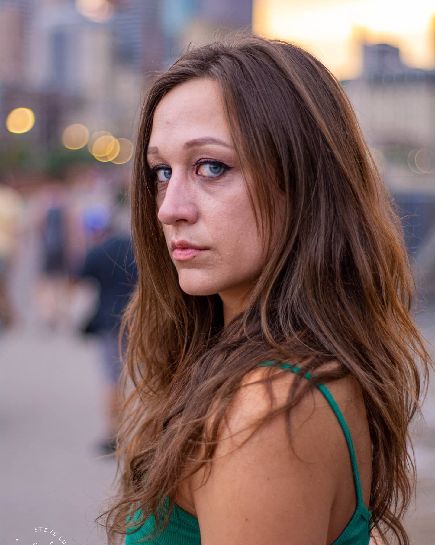 young woman with street scene in background
