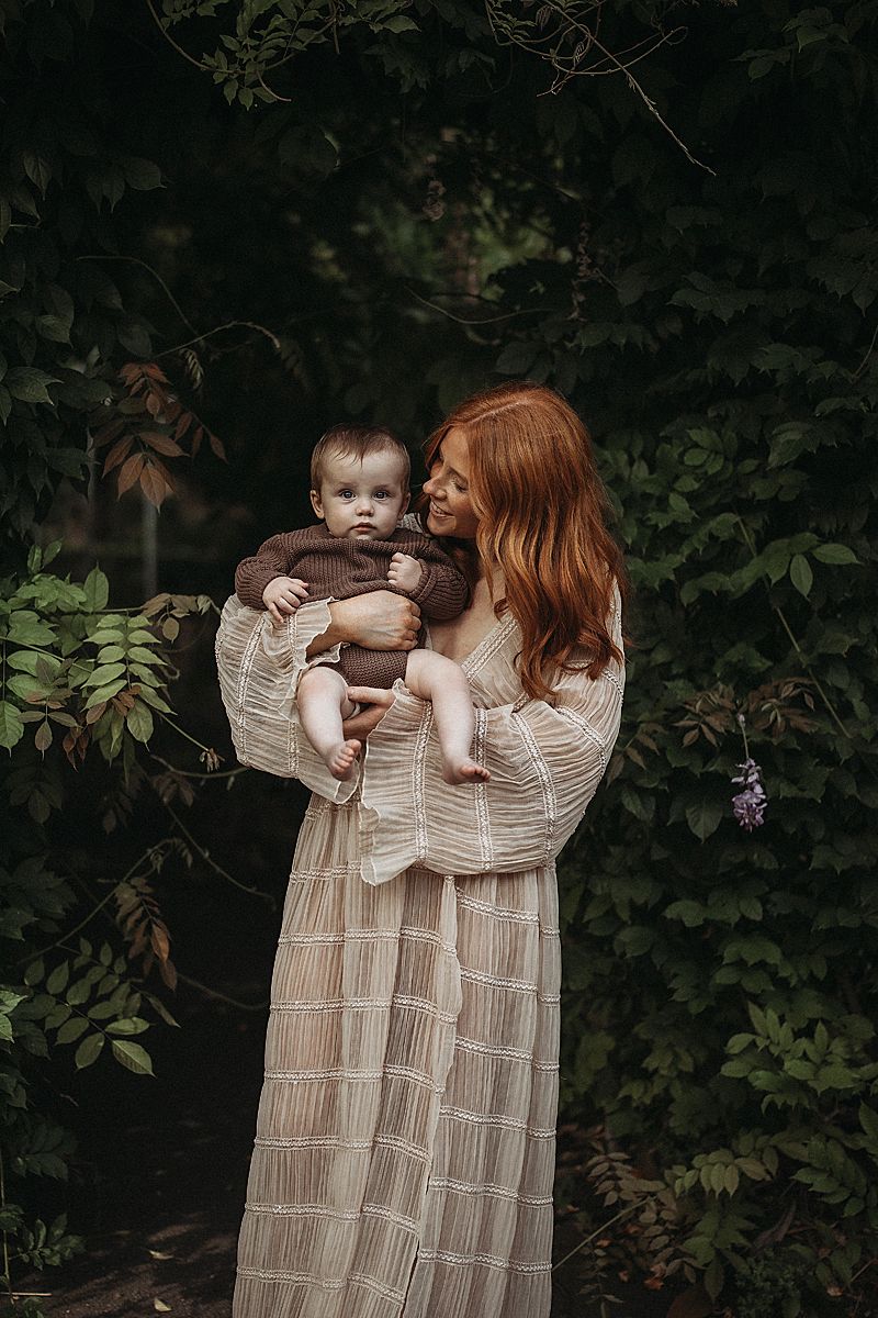 ender portrait of a mother bonding with her baby, photographed in soft neutral tones with an emphasis on emotion
