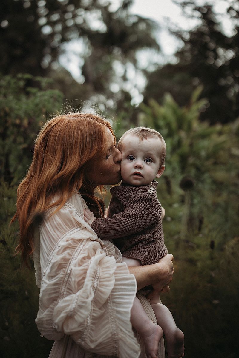 Emotive motherhood portrait of a mum and her twin babies, capturing a peaceful moment of togetherness