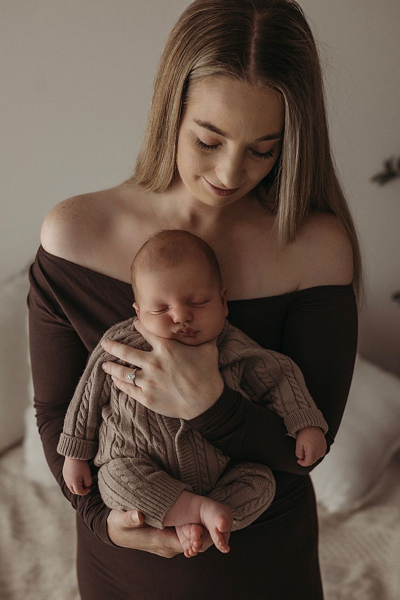 mother cuddling newborn baby studio portrait geelong