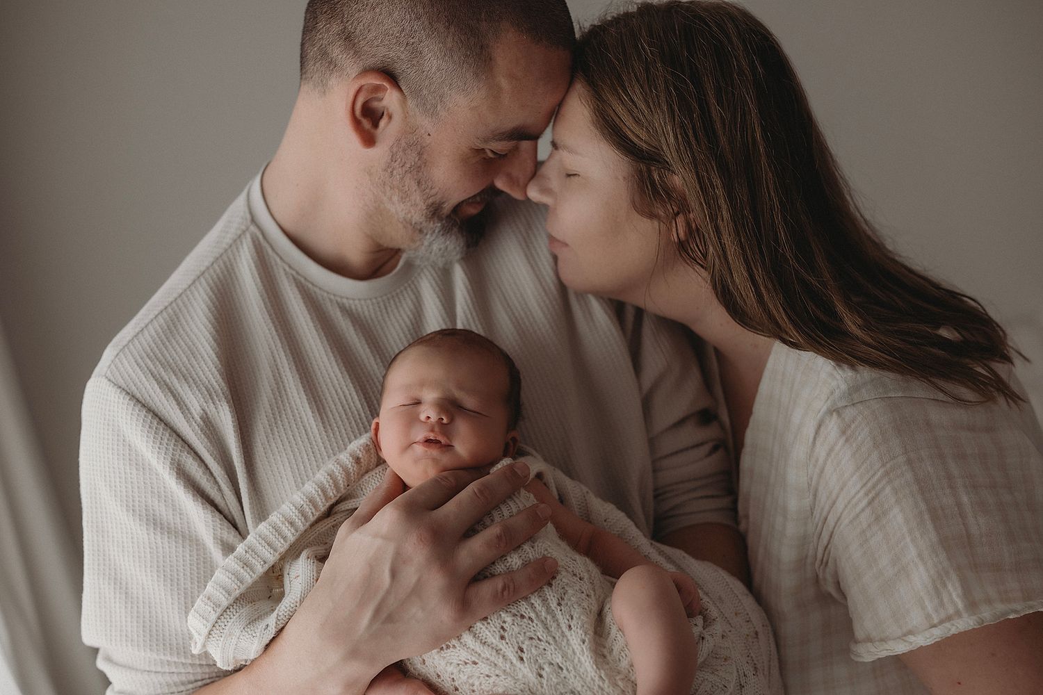 first-time-parents-snuggled-up-close-with-their-new-baby-boy-in-geelong