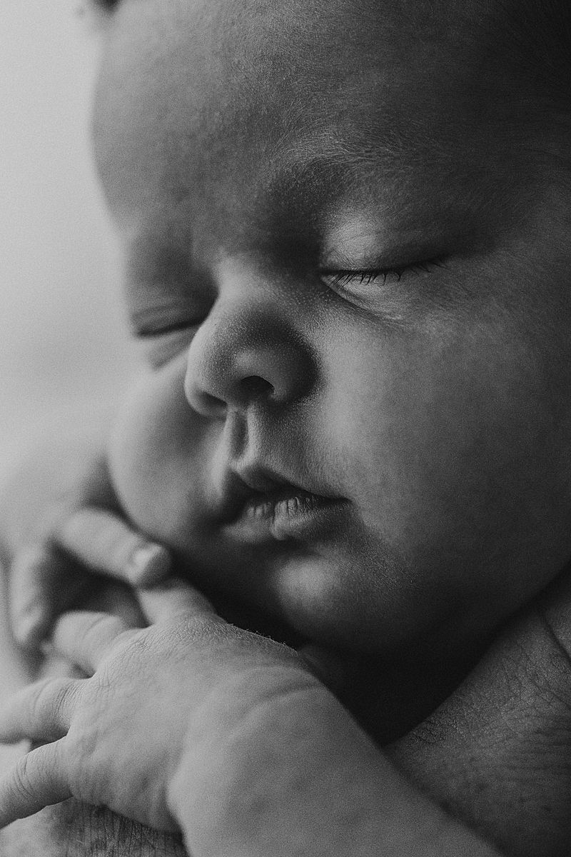 black and white macro of newborn girl sleeping during photoshoot