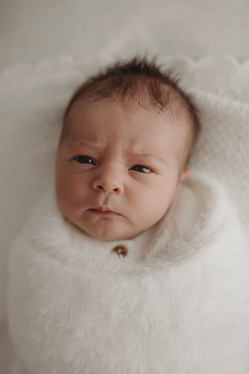 wide awake newborn during geelong photoshoot wrapped in a white blanket