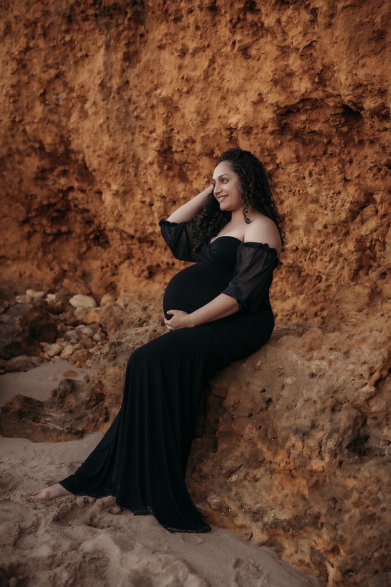 pregnant glowing mum of two inn black dress having photoshoot with geelong maternity photographer lou-lou pictures, at torquay rocky point