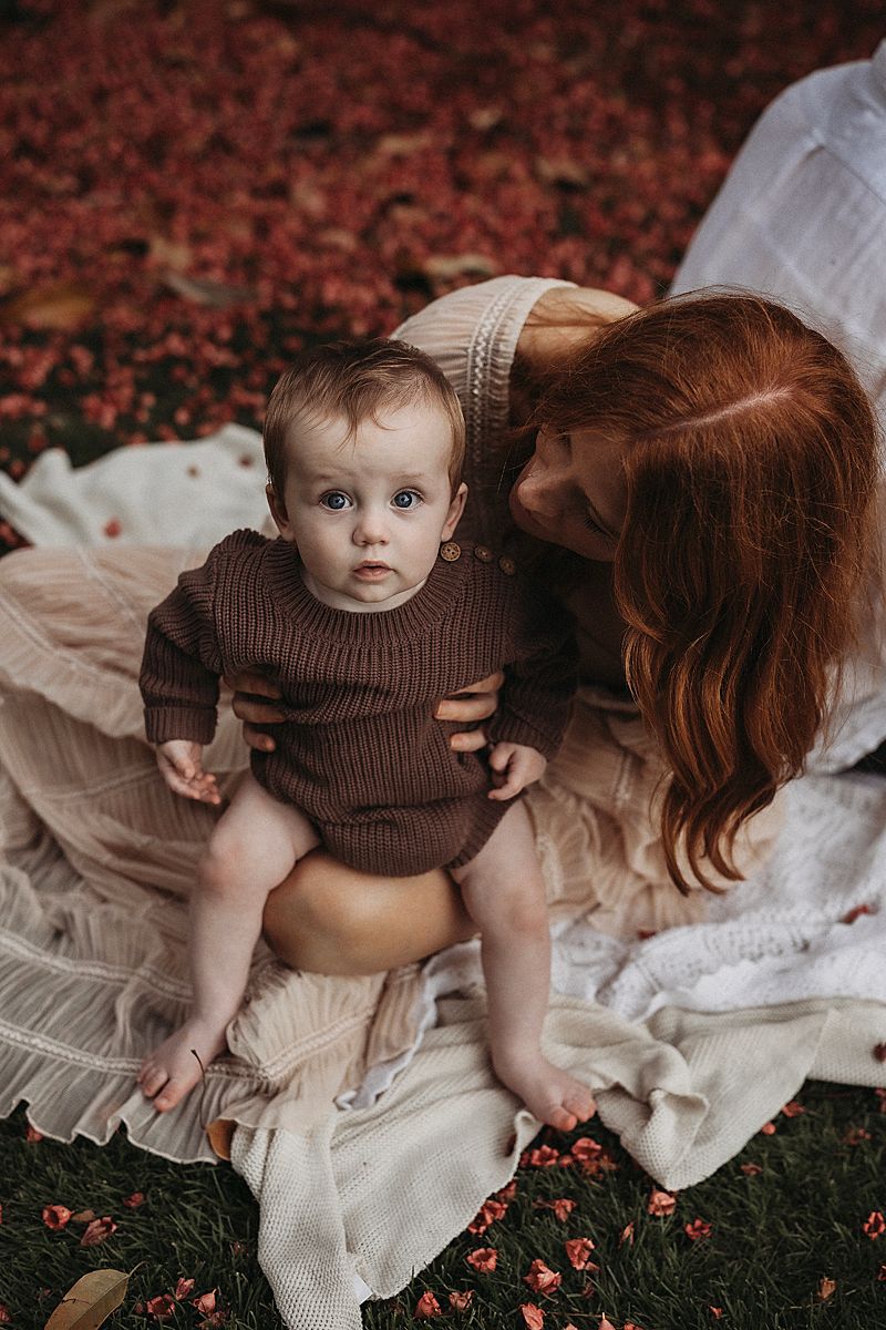mum holding her son close, highlighting the quiet intimacy of early motherhood