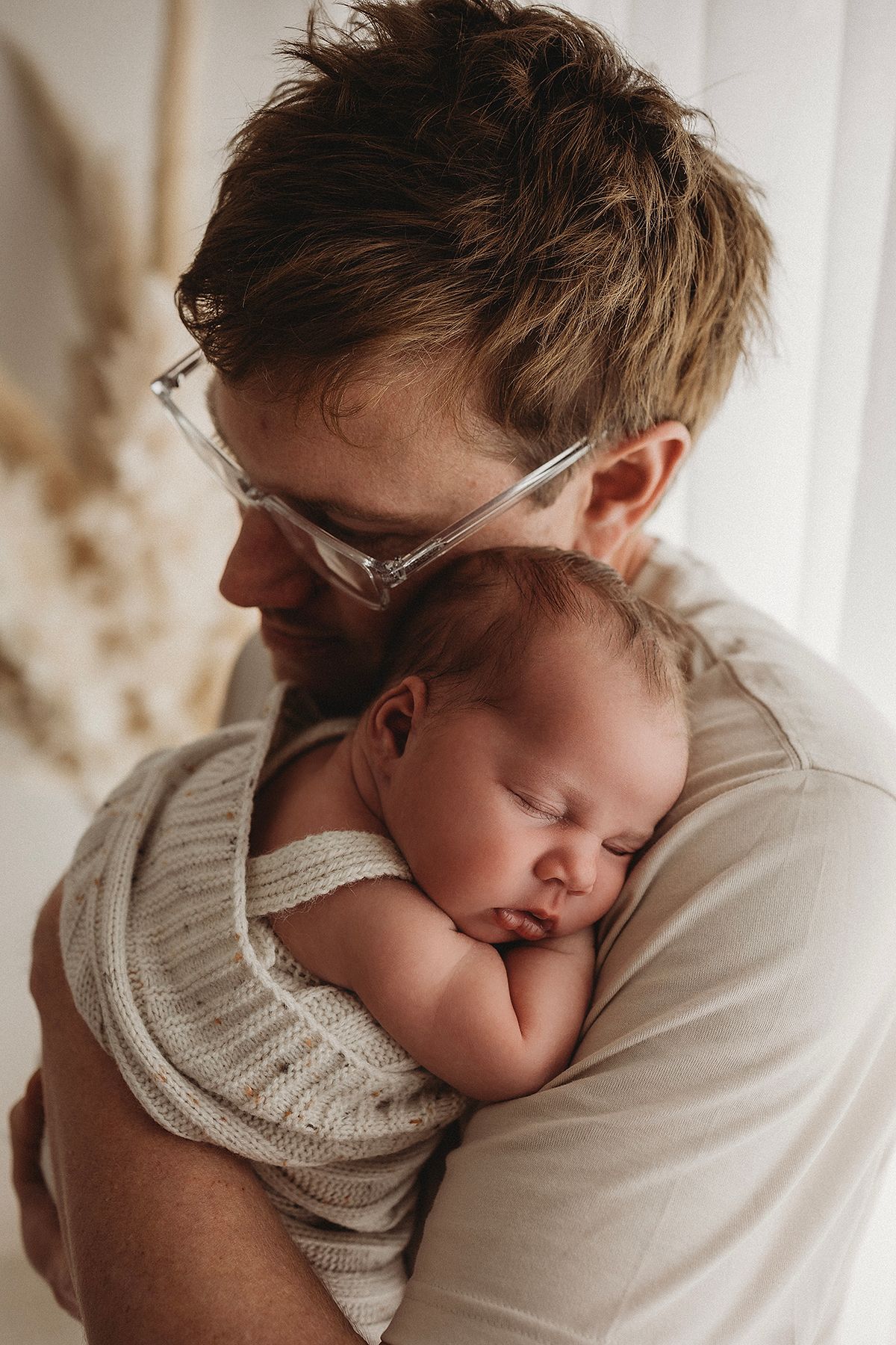 new dad holding newborn baby girl, newborn sleeping in geelong photoshoot