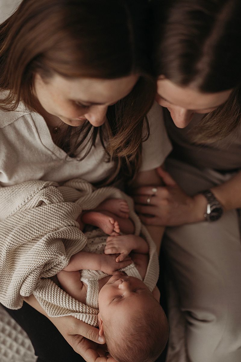 same sex couple with their new baby