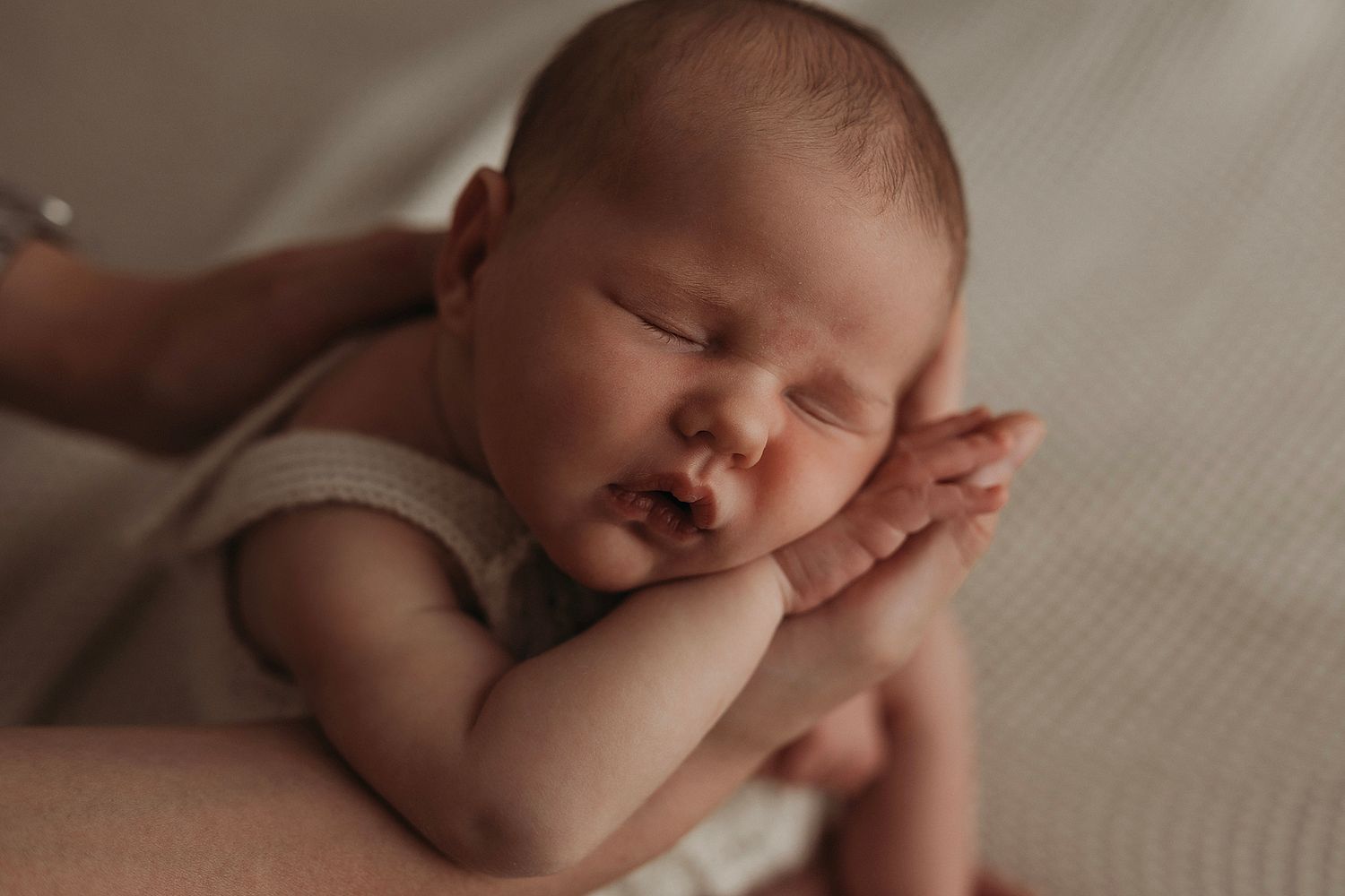 sleeping baby in mums hands, posed by Geelong newborn photographer