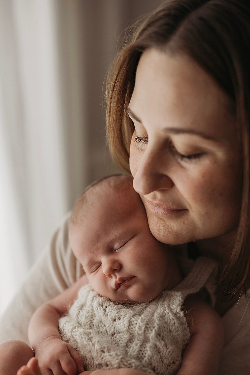 new first time mum cuddling her baby girl