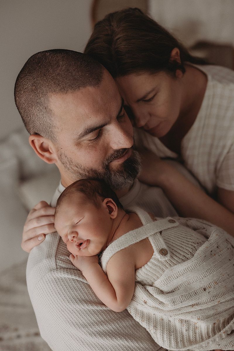 first-time-parents-holding-sleeping-newborn-during-photoshoot-in-geelong