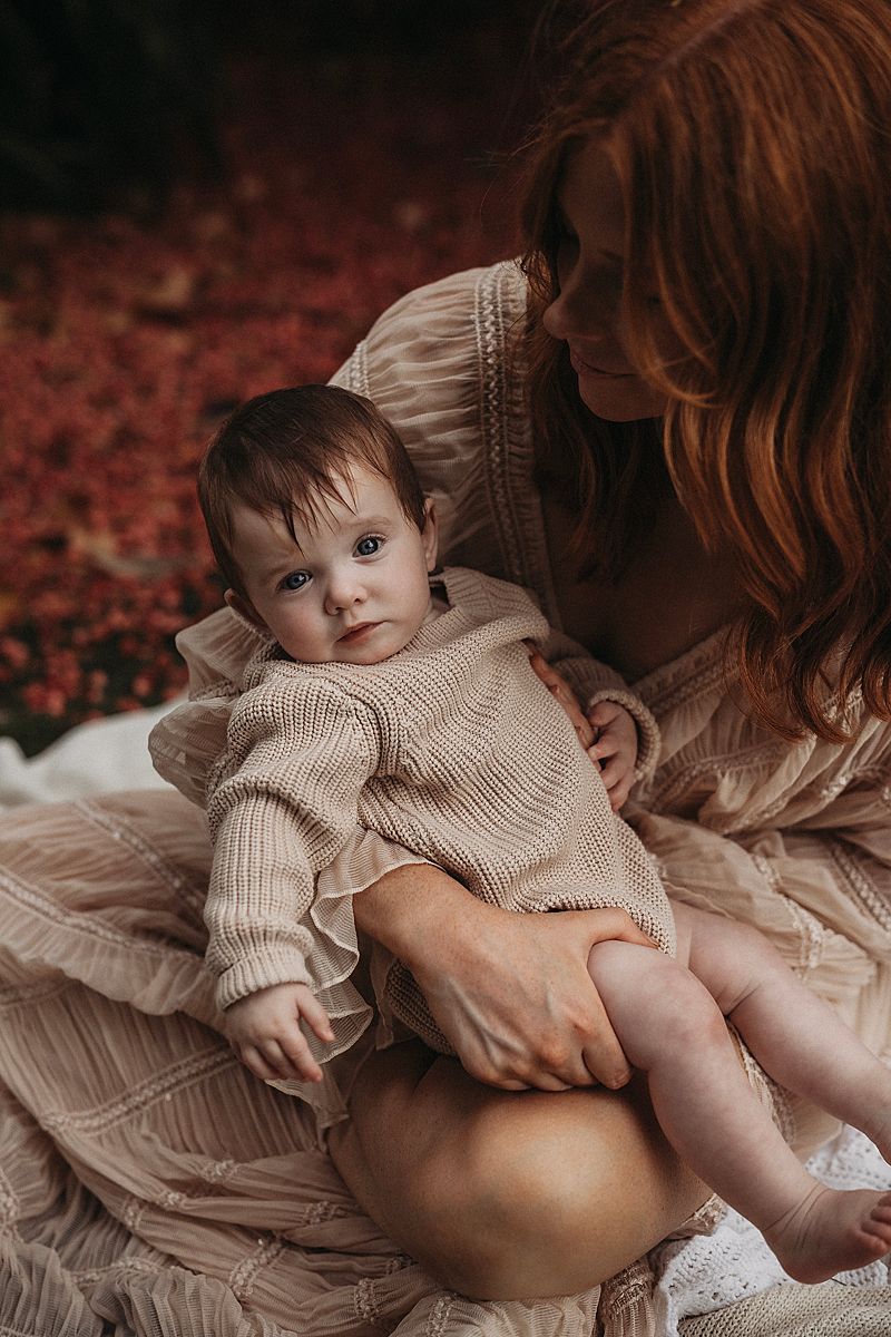 mother bonding with her baby, photographed in soft neutral tones with an emphasis on emotion