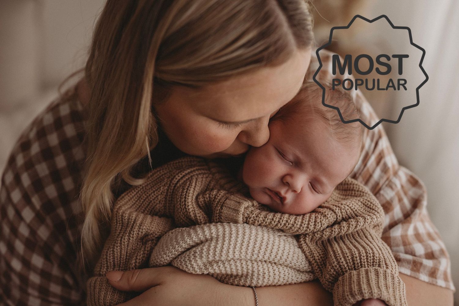 newborn baby snuggled in mums arms, in brown knit jumper for babies, sleepy newborn photography session in Geelong studio