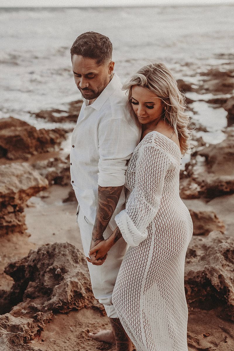 young beautiful couple posing on the beach for engagement session geelong