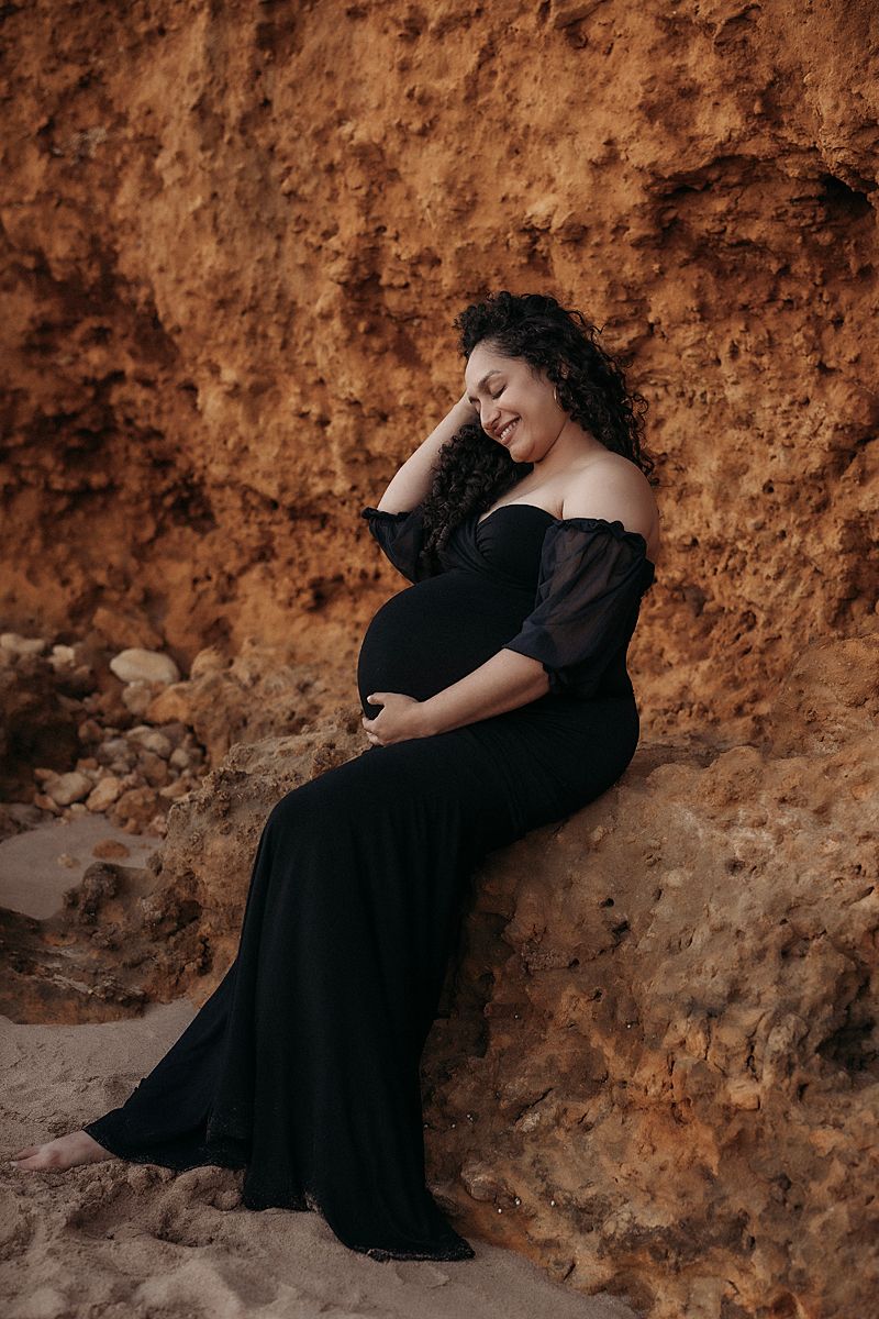 pregnant glowing mum of two inn black dress having photoshoot with geelong maternity photographer lou-lou pictures, at torquay beach