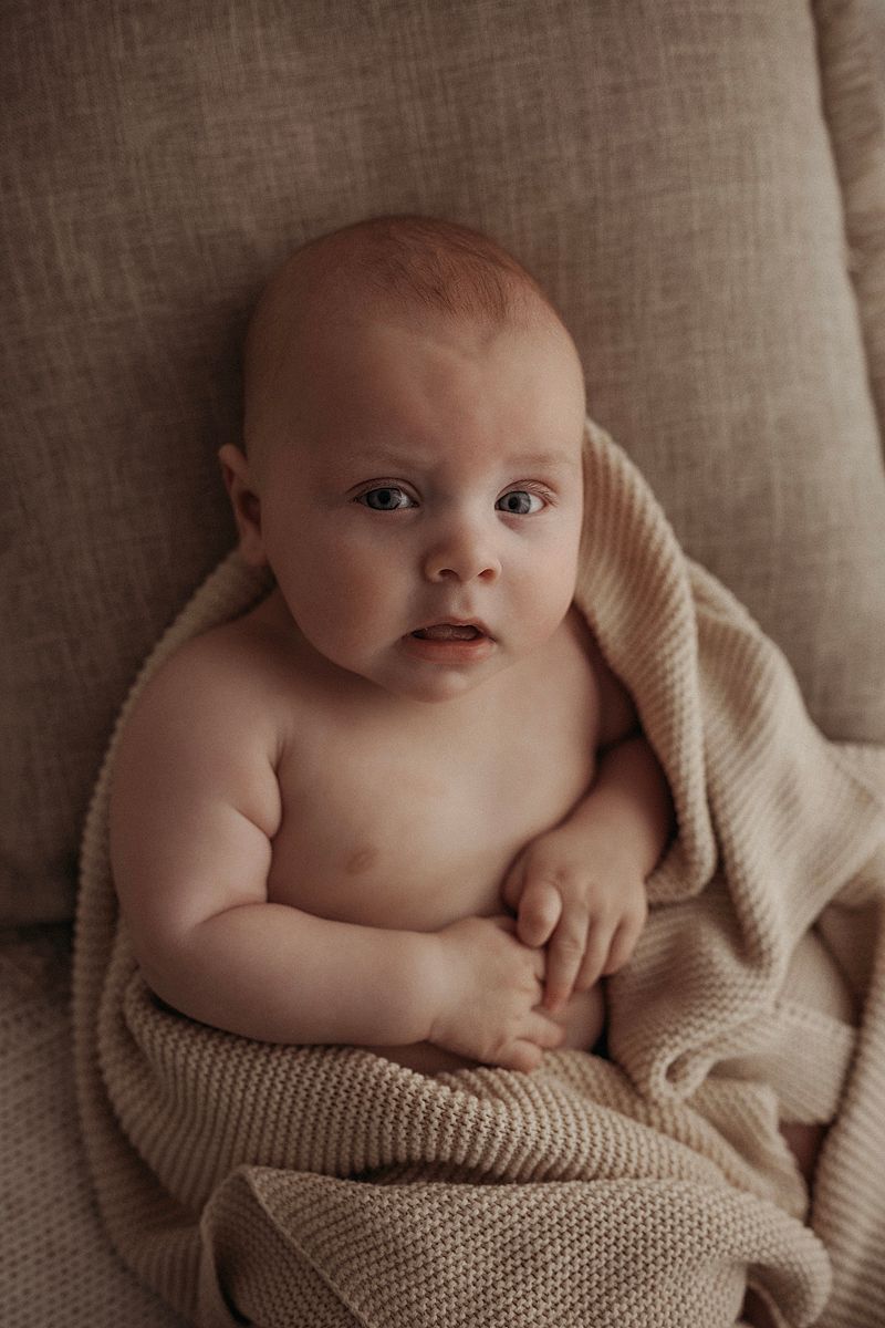 Baby looking towards the camera during a relaxed and natural family photography session in Geelong.