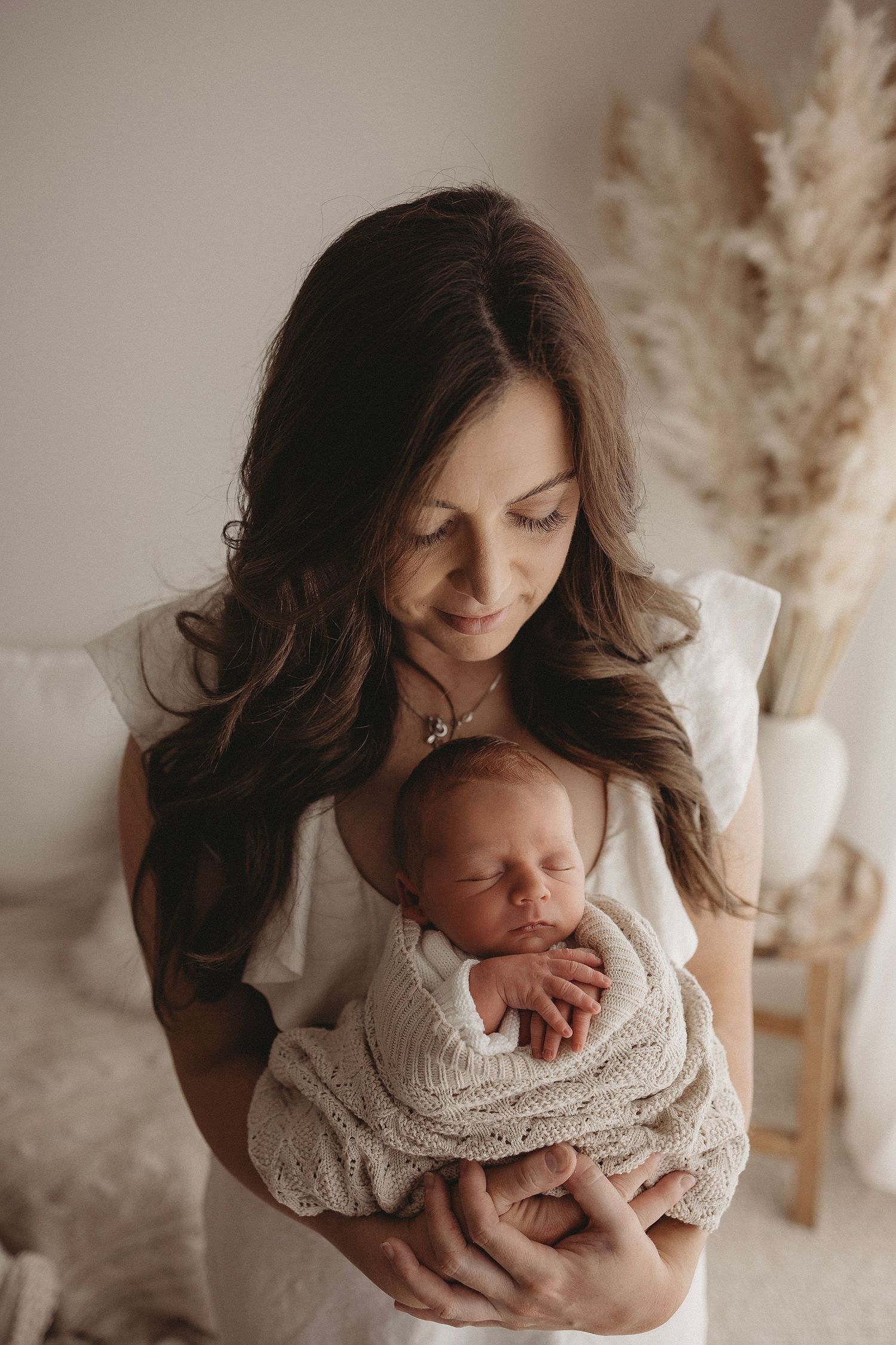 third baby snuggled with mum, sleeping during photoshoot in Geelong home studio