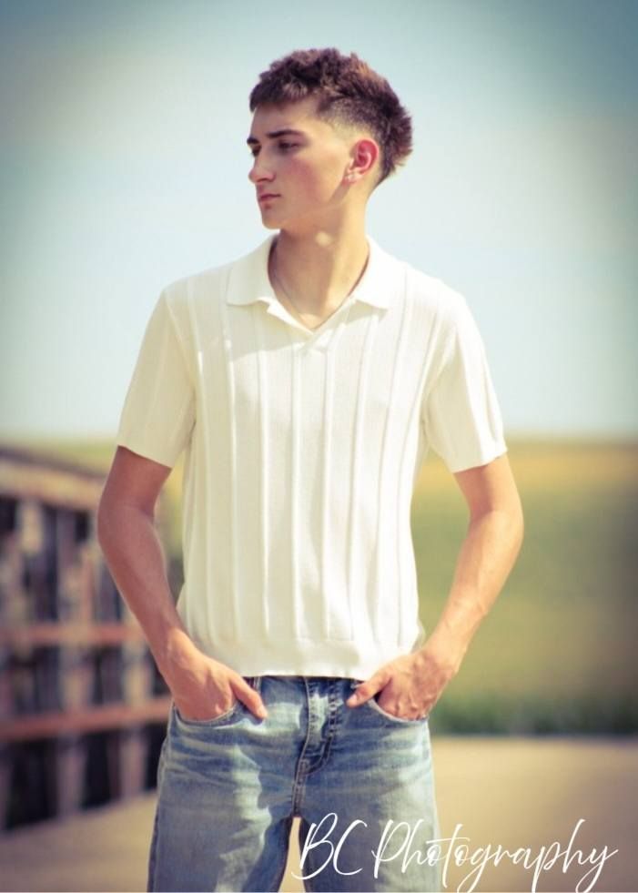 Senior portrait of male posing on bridge outside of Le Mars, Iowa