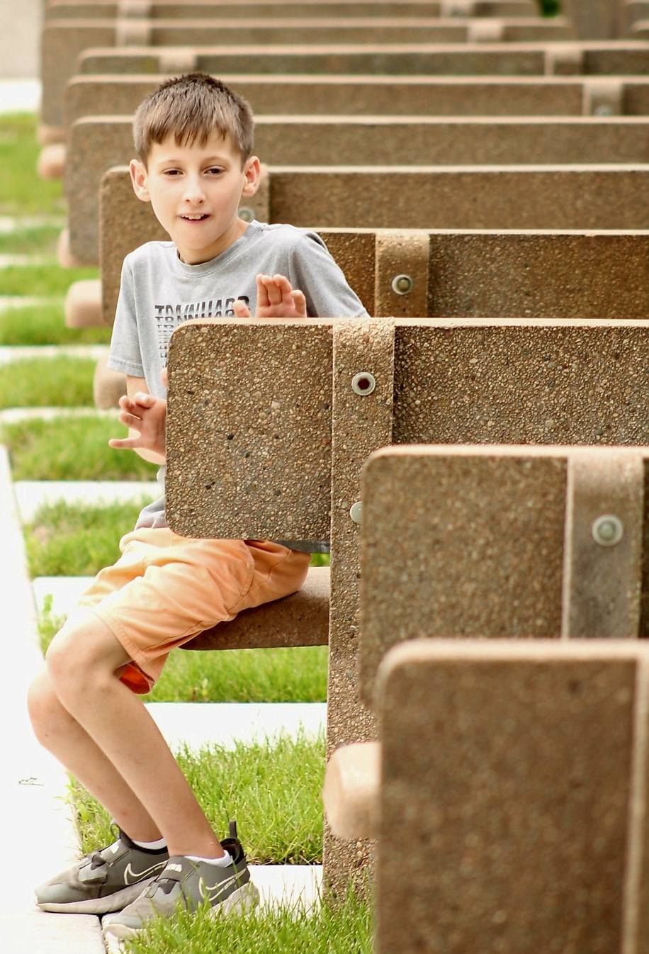 portrait of young boy on benches, Trinity Heights, Sioux City, Iowa